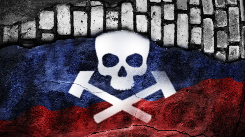 skull and crossed hammers over a russian flag on gray bricks