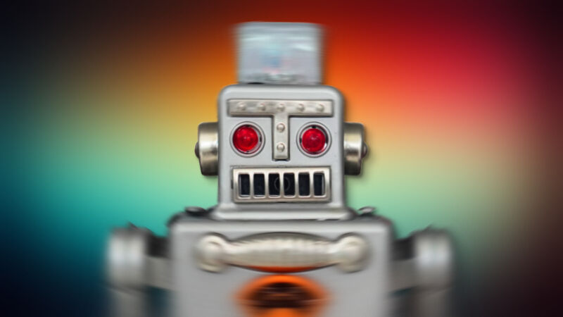 A shaky toy robot on a multicolor background.