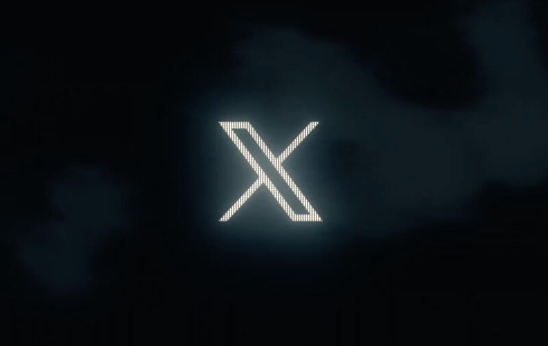 An X on a dark background.