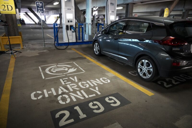 A dark Chevy Bolt charges at an EVgo charger at Union Station in Washington DC