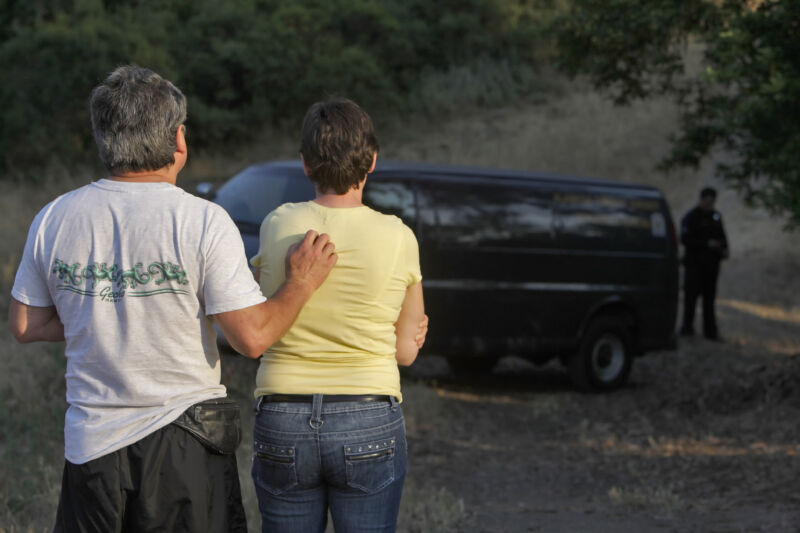 An Alameda County couple watches as investigators prepare to retrieve the body of Nina Reiser in the Oakland hills in July 2008. Hans Reiser, creator of the ReiserFS file system, provided the location after his 2008 murder conviction.