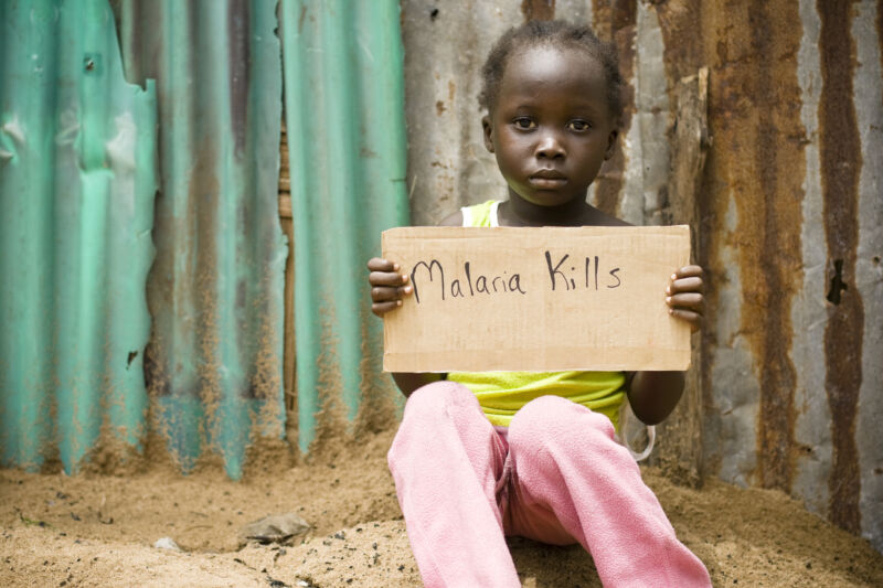 An African girl holding a sign with 