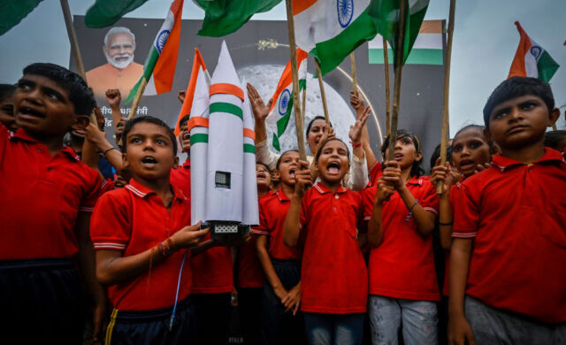 Students celebrate and dance after the Chandrayaan3 Vikram lander successfully landed on the lunar surface at Kartvayapath on August 23, 2023, in New Delhi, India.