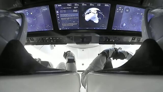 This camera view from SpaceX's live launch broadcast shows the Crew Dragon spacecraft's touchscreen displays, over the shoulders of commander Jasmin Moghbeli and pilot Andreas Mogensen.