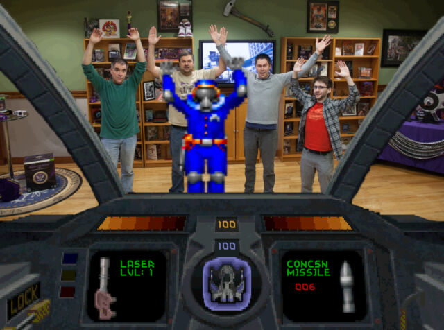 Volition team members pose in a composite with the HUD from <em>Descent</em>, which gave the company its start 30 years ago.