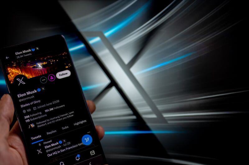 Elon Musk's X profile displayed on a smartphone in front of the new