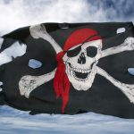 A pirate flag with a skull and crossbones blowing in the wind