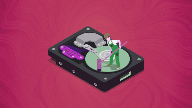 An illustration of a cartoon worker wiping a hard drive.