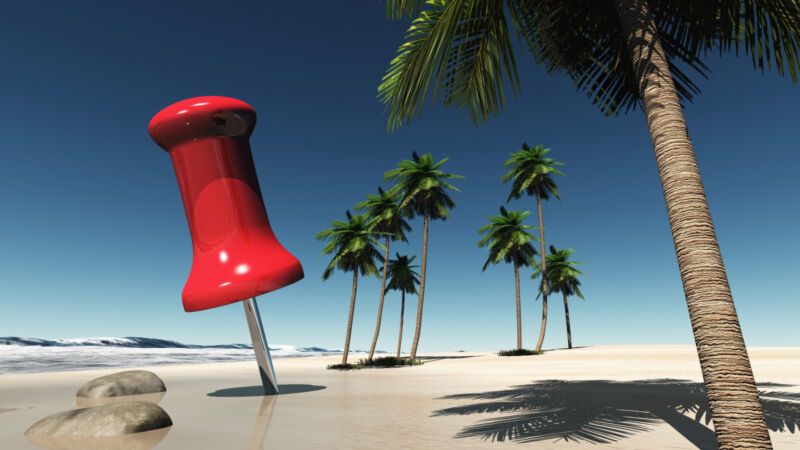 Small Island with palms and a big red pin on the beach