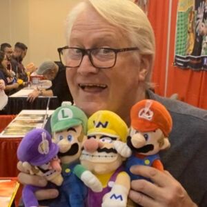 Martinet poses with some of the famous characters he's voiced for decades now.