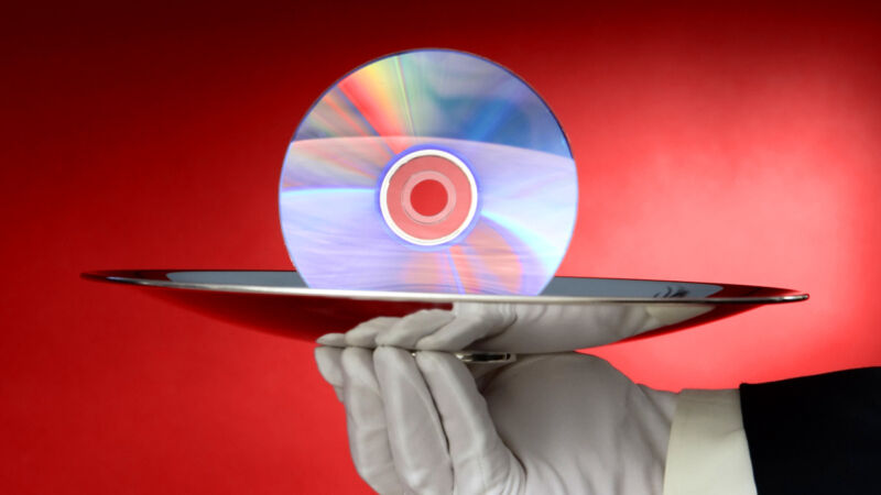 A white-gloved waiter serving up a DVD on a silver platter.