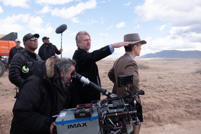 Christopher Nolan directing a scene from <em>Oppenheimer</em>.