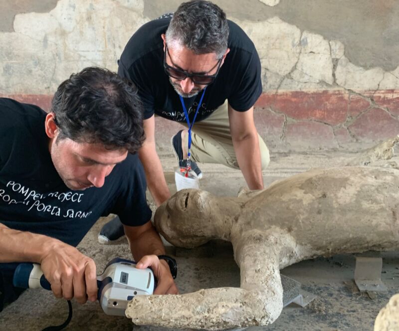 Archeologists Gianni Gallello (front) and Llorenç Alapont (back) measure a plaster cast of a Pompeii victim by pXRF.
