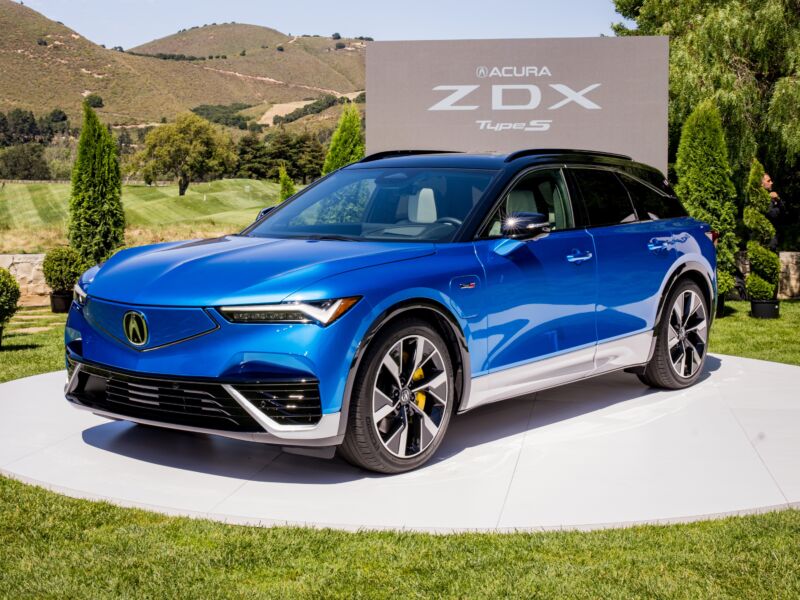 A blue Acura EV on display at a golf course