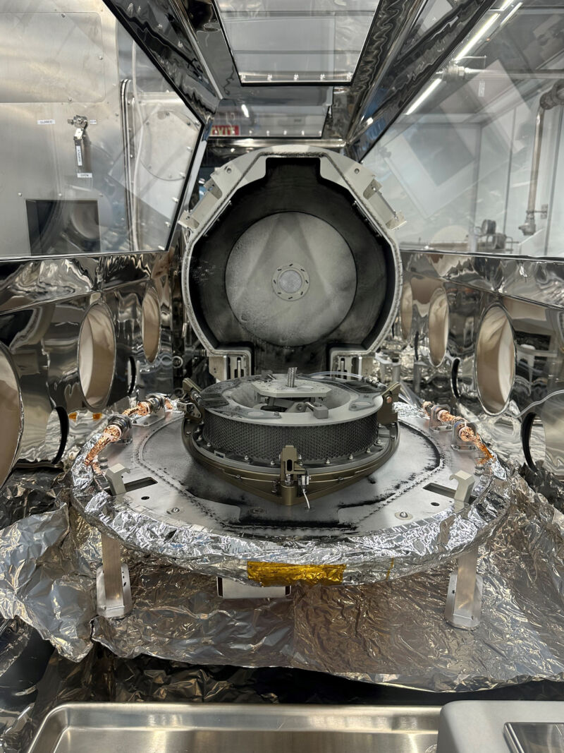 The lid is open on the OSIRIS-REx sample return canister, revealing a tantalizing ring of dust outside the main sample collection chamber.