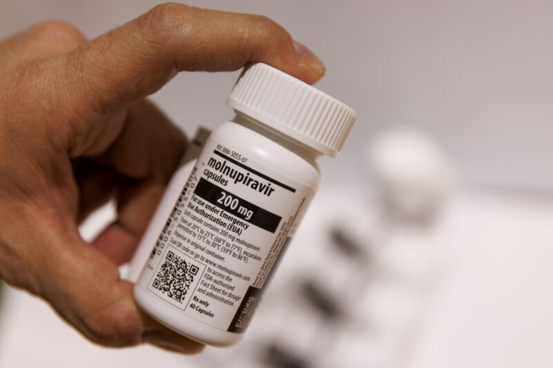 A worker handles a bottle of Merck & Co. and Ridgeback Biotherapeutics LPs molnupiravir antiviral medication in a warehouse in Shoham, Israel, on January 18, 2022.