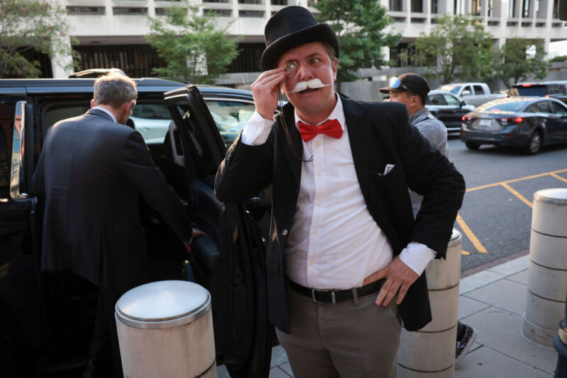 Ian Madrigal, dressed as the Monopoly Man, outside federal court on the first day of the Justice Department's antitrust trial against Google.  