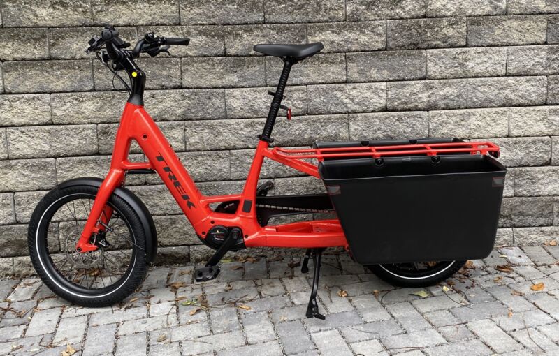 Image of a red bicycle with large plastic tubs flanking its rear wheel.