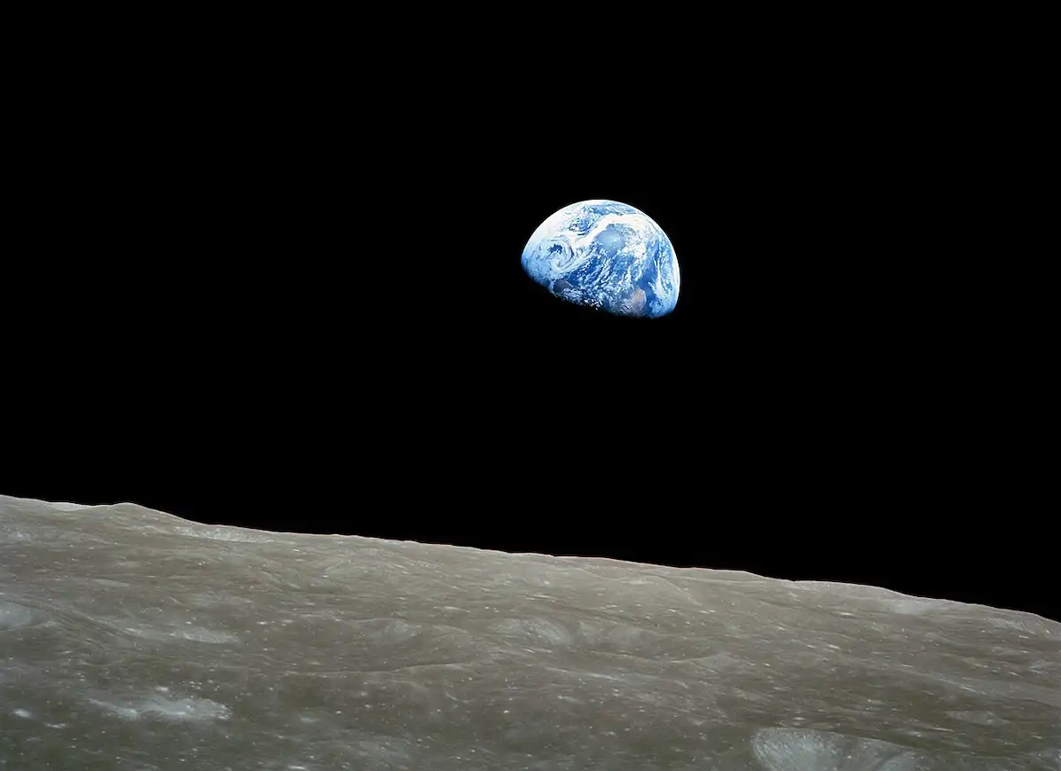 Earth rising over the surface of the Moon