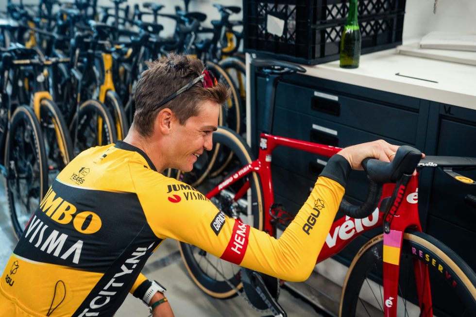 GC Kuss checks out the special paint job on his road bike ahead of the final stage of the Vuelta a Espana.