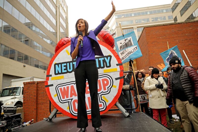 FCC Commissioner Jessica Rosenworcel speaks outside in front of a sign that says