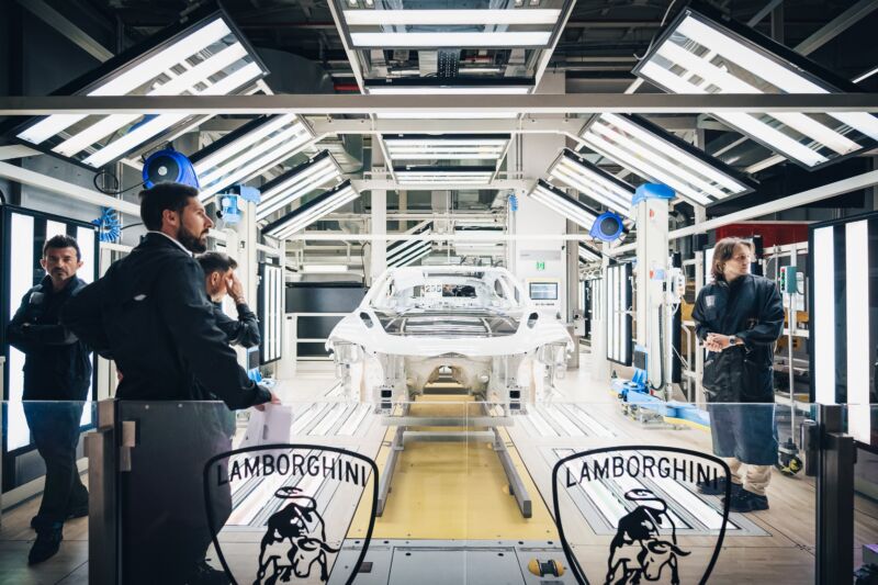A Lamborghini body undergoes inspection at the factory