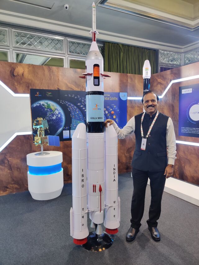 S. Unnikrishnan Nair, head of India's Vikram Sarabhai Space Center, poses with a scale model of the LVM3 rocket with the Gaganyaan spacecraft in launch configuration.