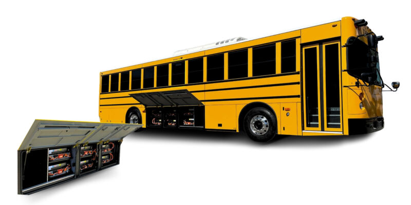 A yellow school bus with large battery packs next to it