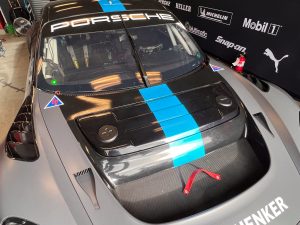 The front battery cover of the 718 GT4 ePeformance. It has + and - signs on it
