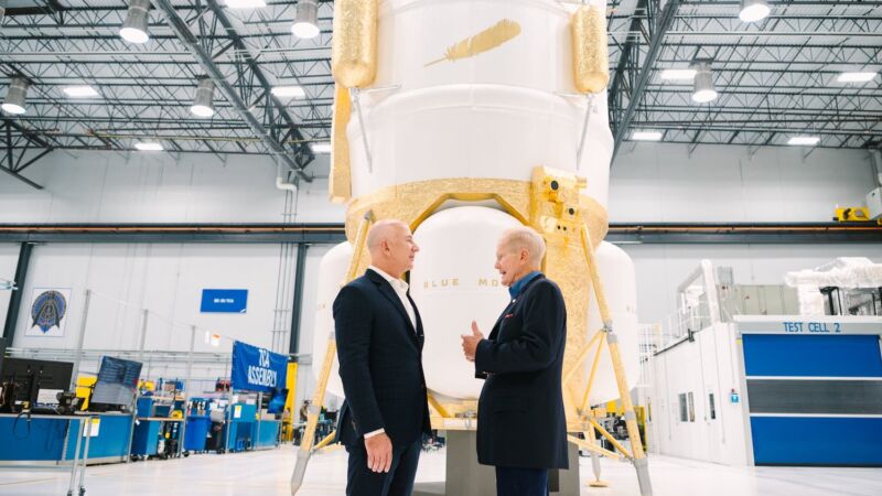 Jeff Bezos, Blue Origin's founder, meets NASA Administrator Bill Nelson with a mock-up of the Blue Moon Mark 1 lander behind them.