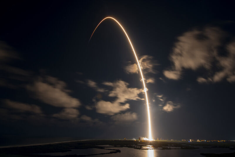 A Falcon 9 rocket climbs into orbit from Cape Canaveral, Florida, with 22 Starlink satellites Tuesday night in this long-exposure photo. 