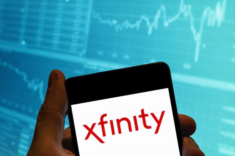 A Comcast Xfinity logo displayed on a smartphone. A stock exchange graph is shown in the background behind the phone.