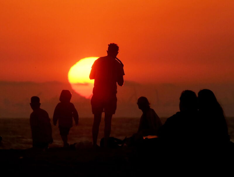 figured silhouetted against the setting sun