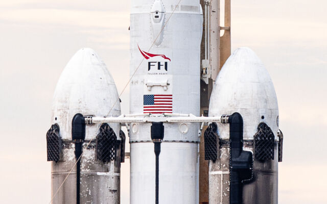 The Falcon Heavy's two side boosters bear the marks of three previous flights to space. The rocket's core stage is new. 