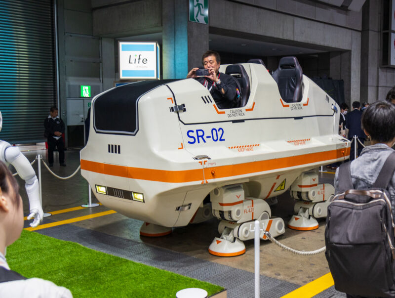 A person rides in the Sansei SR-02 walker at the 2023 Japan Mobility Show
