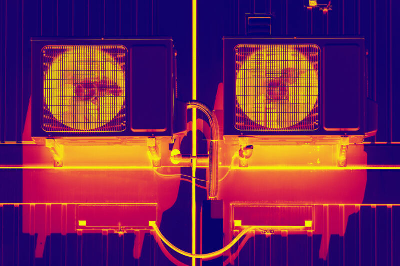 Thermal imaging of two heat pumps and fan units, showing red and orange areas with elevated temperatures.