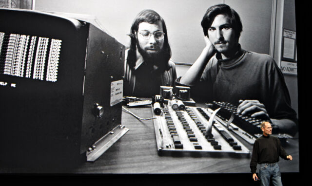 Steve Jobs speaks in front of a file photograph of himself and Apple cofounder Steve Wozniak during the launch of the iPad on Wednesday, Jan. 27, 2010.