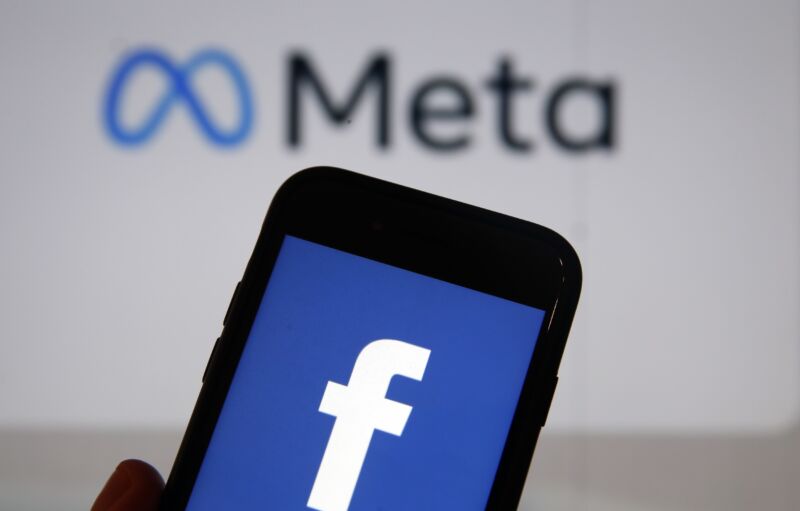 Photo illustration in which the Facebook logo is displayed on the screen of an iPhone in front of a Meta logo