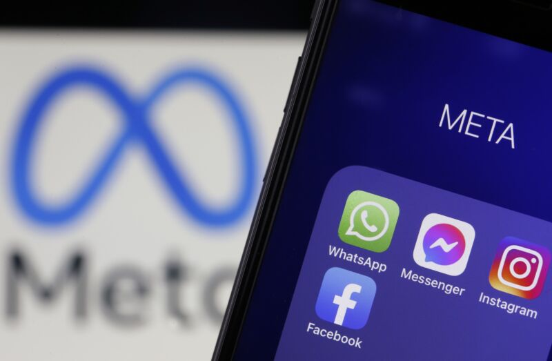 In this photo illustration, the icons of WhatsApp, Messenger, Instagram and Facebook are displayed on an iPhone in front of a Meta logo