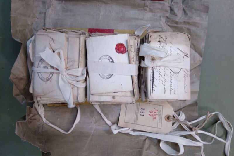 bundles of 18th century letters in three piles