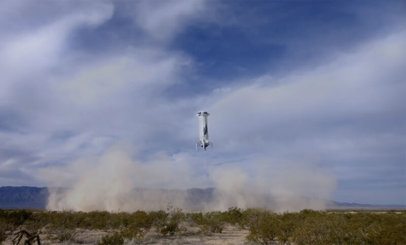 Blue Origin's New Shepard booster comes in for landing in West Texas at the conclusion of Tuesday's suborbital flight.