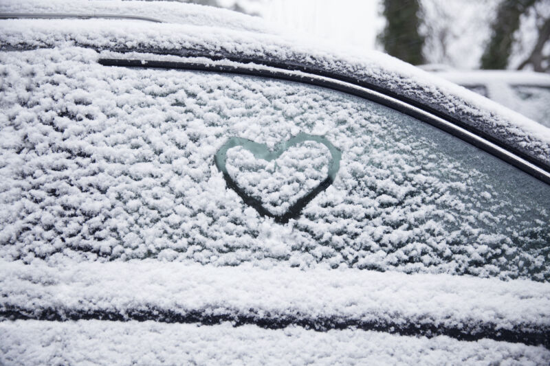 Heart shape in snow on car.