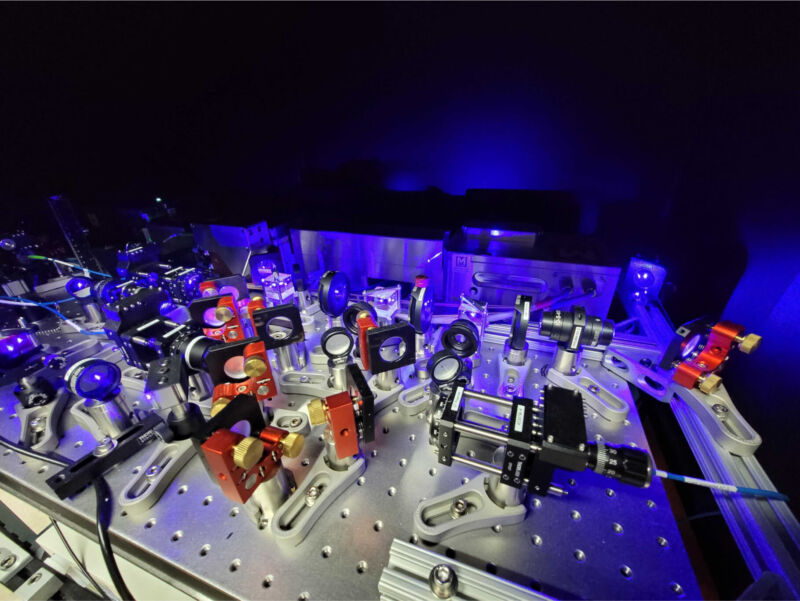 Image of a table-top optical setup, with lots of lenses and mirrors in precise locations.