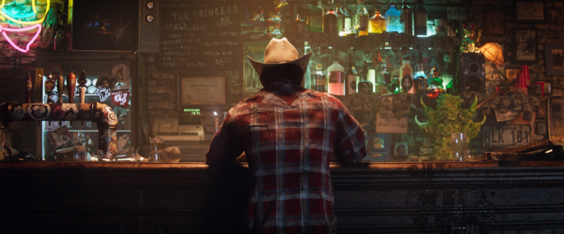 Wolverine sits at a bar in a game screenshot