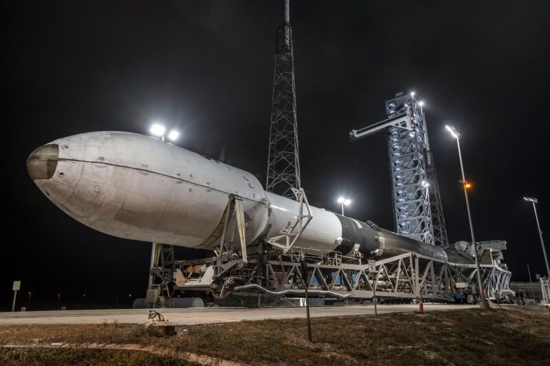 A SpaceX Falcon 9 rocket with a reused booster stage and payload fairing  is seen rolling out to its launch pad in Florida before a mission last month.