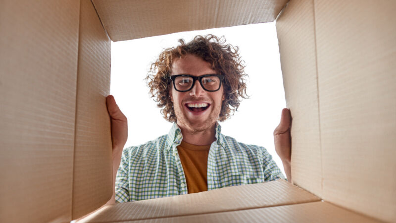 Photo of a man looking into a box.