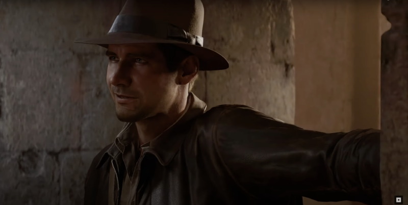 Indiana Jones in front of an alcove in a ruin.