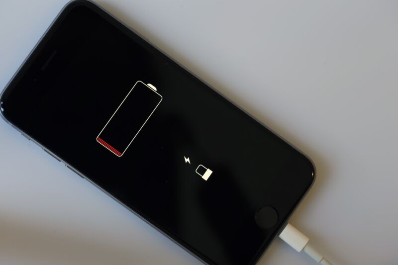 Un iPhone que se ha quedado sin energía muestra una pantalla negra con un ícono de batería baja.