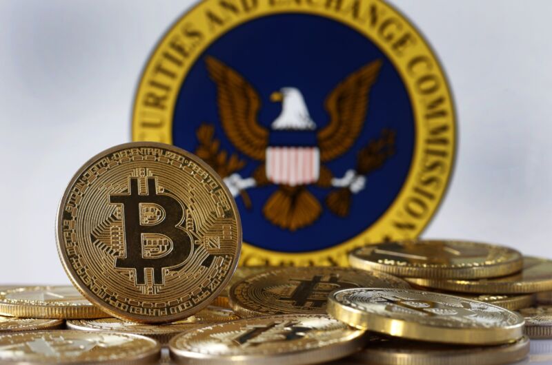 Gold coins with the bitcoin logo are pictured in front of the Securities and Exchange Commission seal.