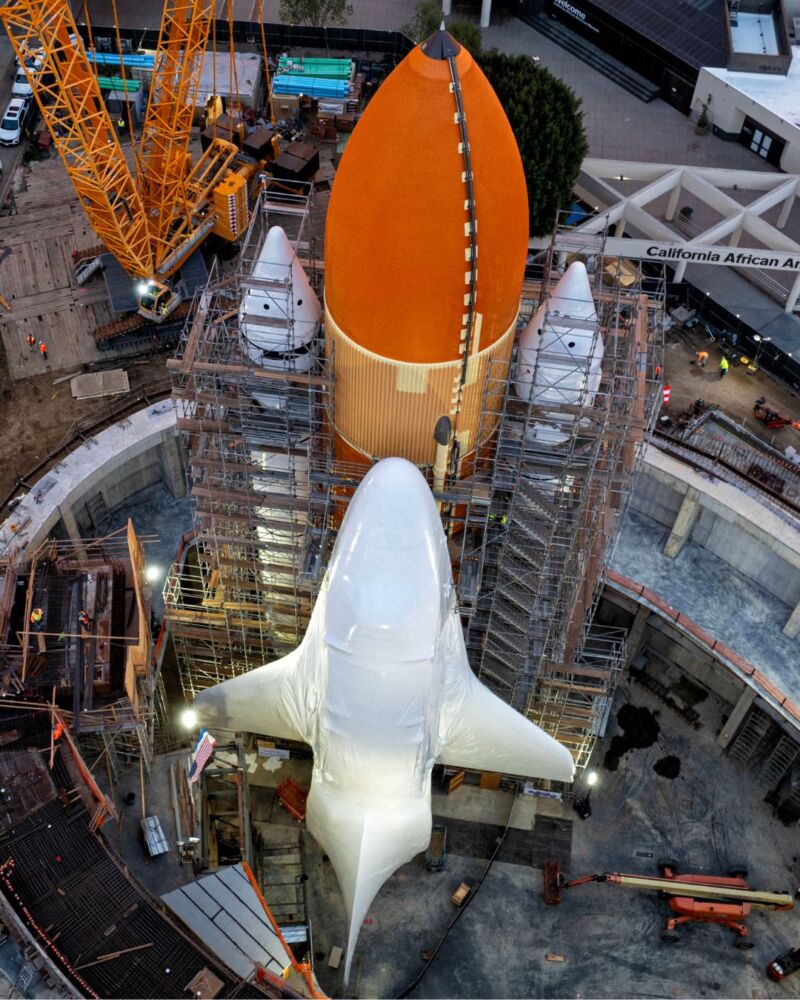 Space shuttle Endeavour, seen here in protective wrapping, was mounted on an external tank and inert solid rocket boosters at the California Science Center.